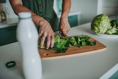 Midsection of man preparing food in kitchen