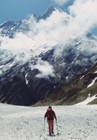 Rear view of hiker on snowcapped mountain. hiking to the machhapuchhre mount summit himalayas nepal