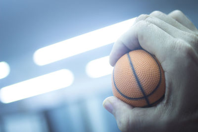 Close-up of hand holding ball at home