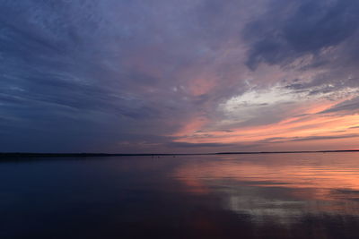 Scenic view of sea against dramatic sky during sunset