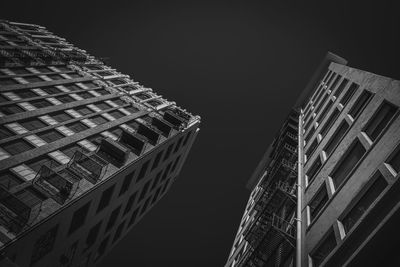 Low angle view of illuminated buildings against clear sky at night