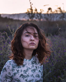 Portrait of woman standing on field