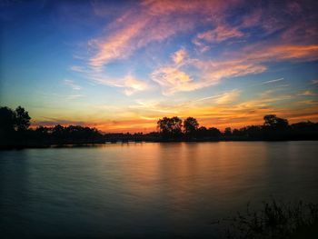 Scenic view of lake against sky during sunset