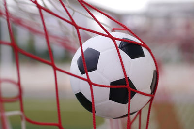 Close-up of soccer ball in goalpost