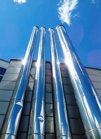 Low angle view of modern building against blue sky