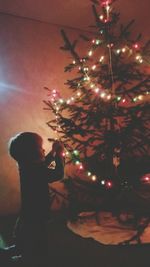 Man holding christmas tree at night