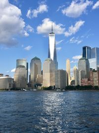 Buildings in city against cloudy sky