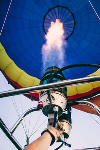 Cropped hand of man flying in hot air balloon