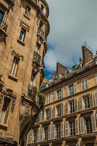 Facade of old typical building with balconies, windows and sunny day in paris. france.