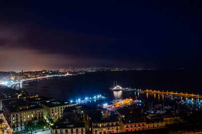 High angle view of city lit up at night