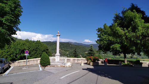 Statue in park against blue sky