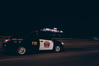 Car on illuminated road at night