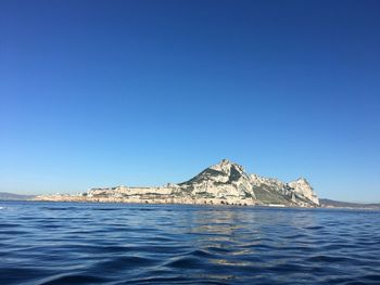 Scenic view of sea against clear blue sky