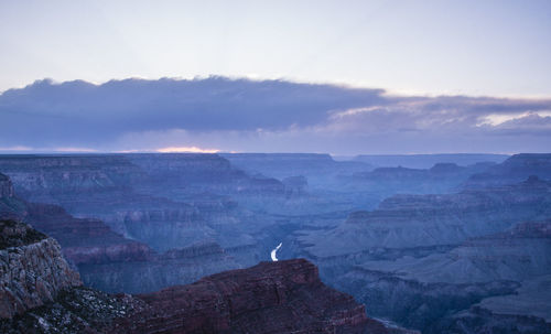 Scenic view of mountain range against cloudy sky