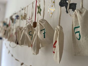 Close-up of clothes hanging against white wall