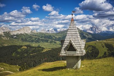 Old built structure by landscape against sky at south tyrol