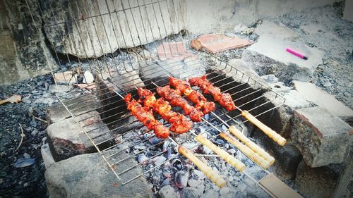 High angle view of meat on barbecue grill