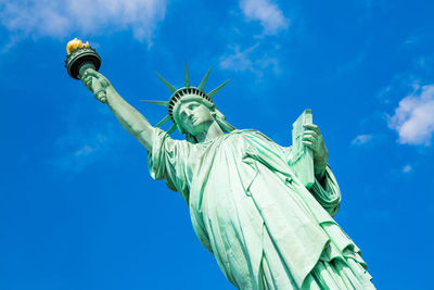 Low angle view of statue against blue sky