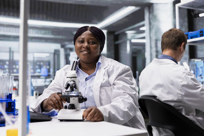 Portrait of young man using mobile phone in office