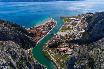 High angle view of townscape by sea