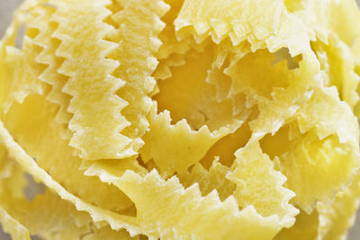 Beautiful nest of pasta fettuccine , thin ribbons of pasta with geometrical edges and rough surface