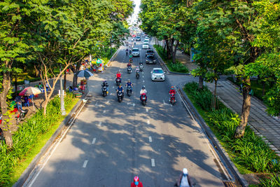 High angle view of people walking on road in city