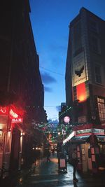 Illuminated city street and buildings at night