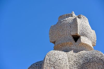 Low angle view of statue against blue sky