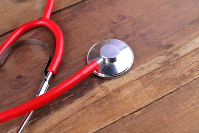 Close-up of red stethoscope on table