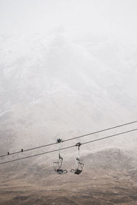 Ski lift against mountain