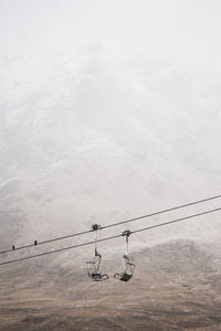 High angle view of overhead cable car against sky