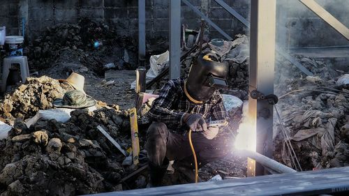 Worker welding at construction site