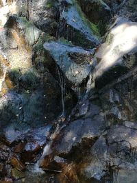 Close-up of water flowing through rocks in river