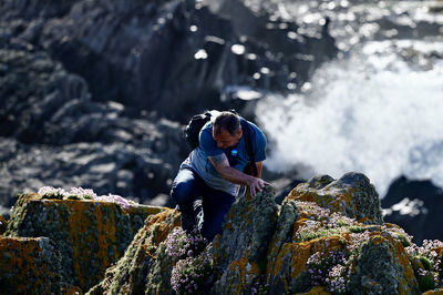 Man looking at rock formation