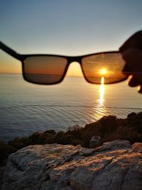 Close-up of sunglasses on rock