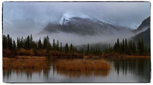 Scenic view of lake and mountains against sky