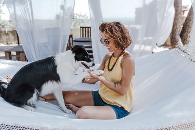 Young woman with dog sitting outdoors