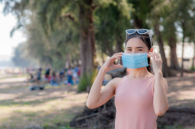 Portrait of woman wearing mask at beach