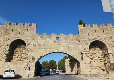 Low angle view of historic building against clear blue sky