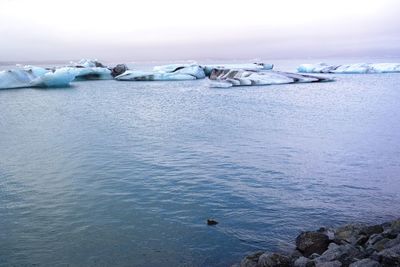 Scenic view of sea against sky during winter