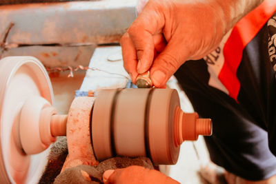 Cropped image of worker shaping metal