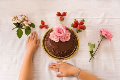 High angle view of cake and roses on table