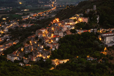 High angle view of illuminated buildings in city at night