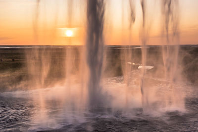 Water splashing in sea during sunset