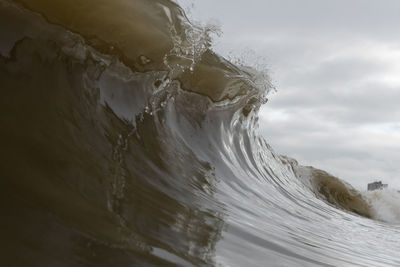 Close-up of a wave against sky