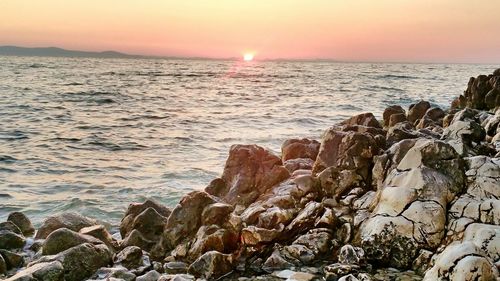 Scenic view of sea against sky during sunset