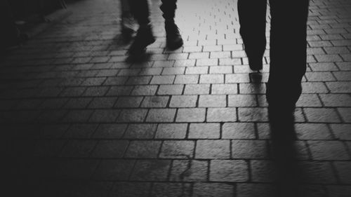 Low section of people walking on footpath