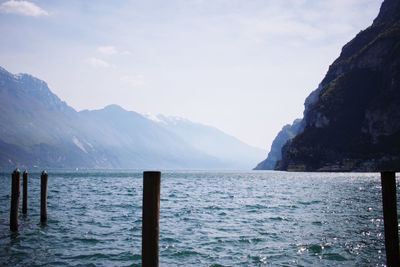 Scenic view of sea and mountains against sky