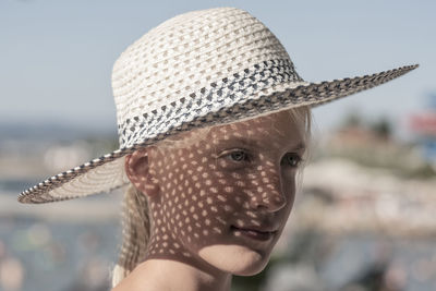 Close-up of girl looking away while wearing hat
