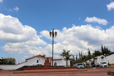 Houses by building against sky